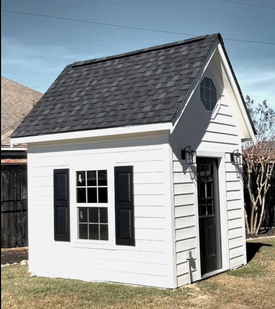 White custom shed with black shutters